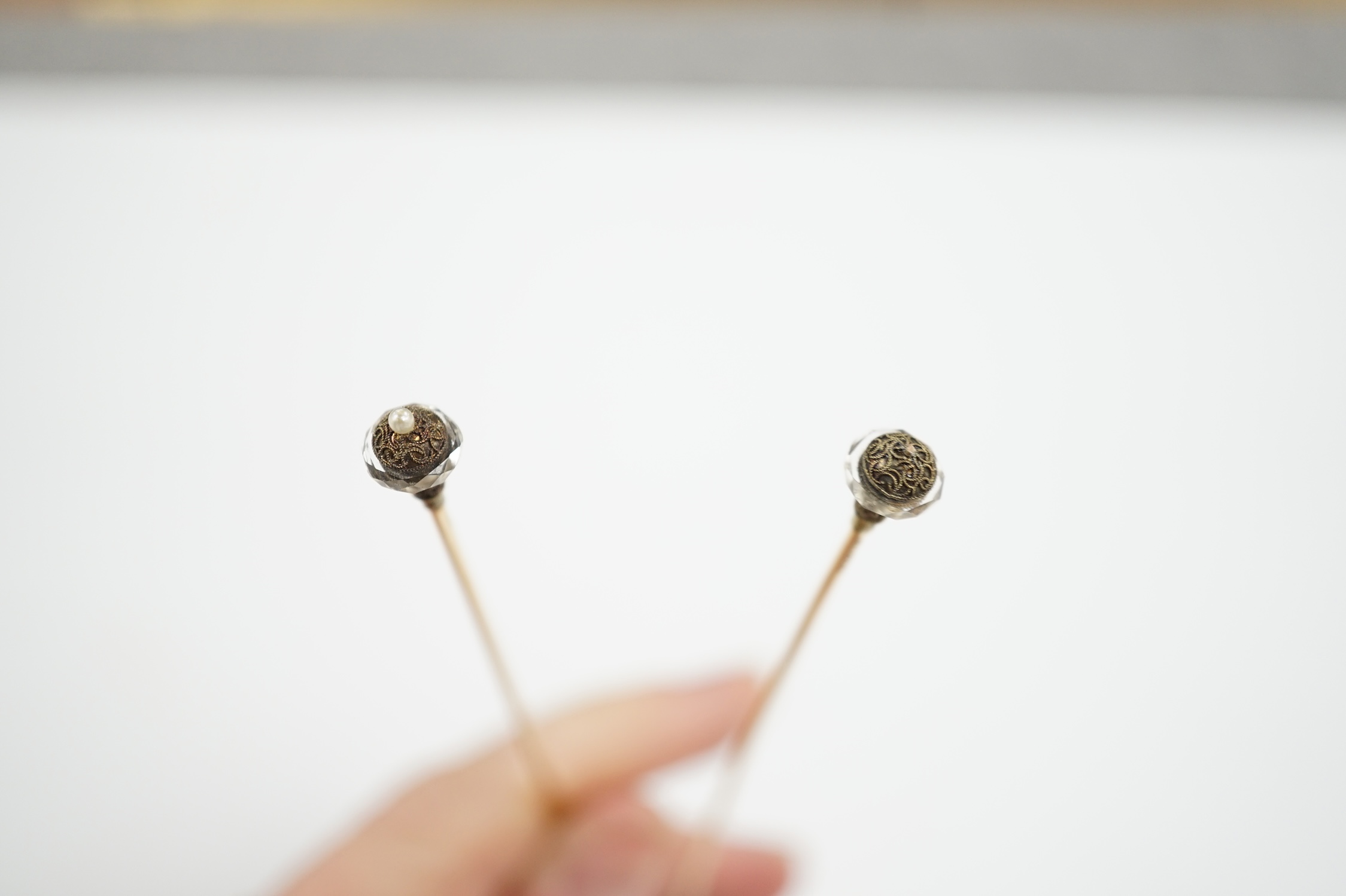 A pair of seed pearl set 'filled pin' hatpins, one a.f. 16cm.